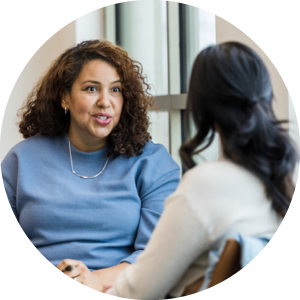 Female AGPAL Surveyor discussing improvement strategies with another healthcare professional